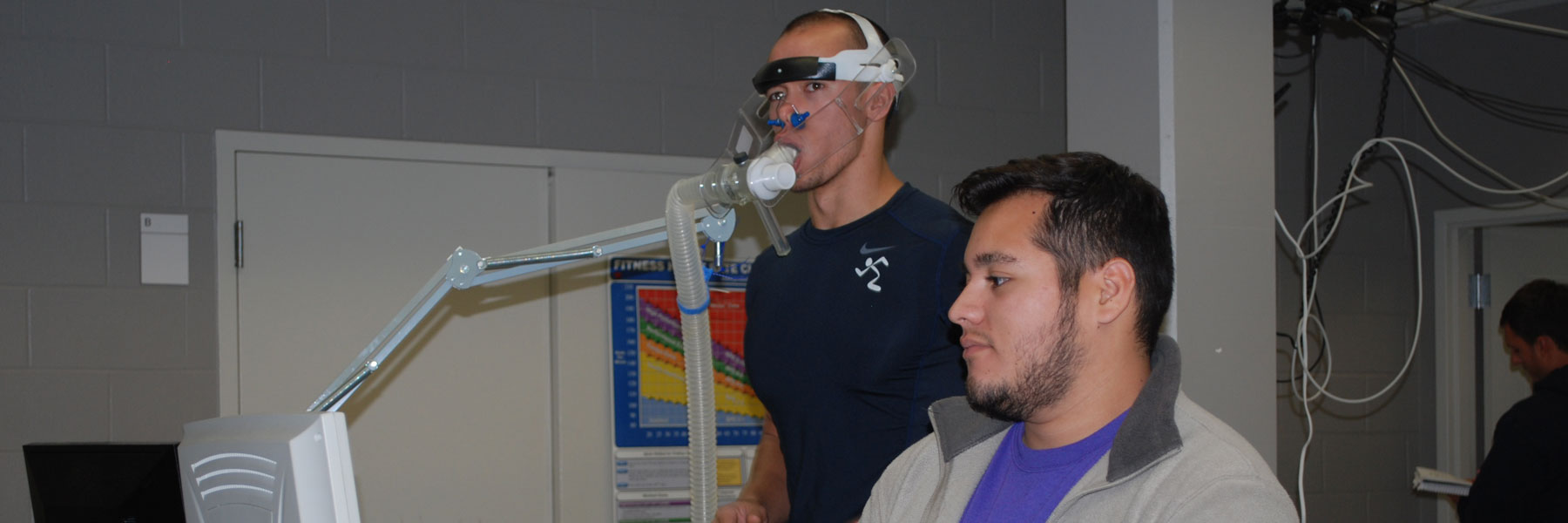 student hooked up to a breathing machine while running on a treadmill 